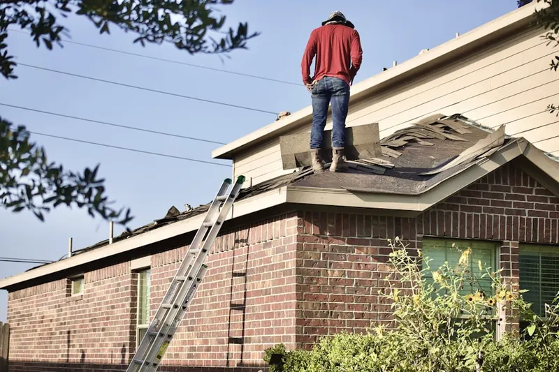 Professional roofer working on a residential roof in East Germantown